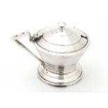 An Art Deco silver plate mustard pot of stylised conical form with blue glass liner 2 3/4" high