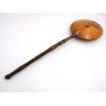 A 19thC brass and copper hot water bed warming pan with turned wooden handle unscrewing.