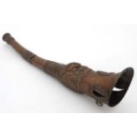 A copper Tibetan horn used in religious ceremony with embossed dragon head motifs 16 1/2" long