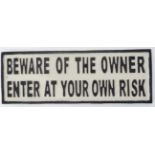 A 21st C painted metal sign 14" x 5" "Beware of the Owner enter at your own risk"