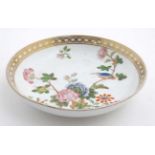 A small Oriental style bowl decorated to centre with a flowering bough of peonies and exotic bird,