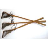 A collection of 3 wooden Hattersley , England 'Viktoria' Lacrosse sticks. 44'' high.