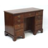 An early Georgian mahogany kneehole desk with front to back oak drawer linings 46" wide x 22" deep