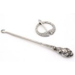 A silver handled button hook marked 'Sterling' together with a Celtic penanular brooch marked '
