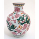 A Chinese vase of ovoid form decorated with 5 clawed dragons fighting over flaming pearls of wisdom