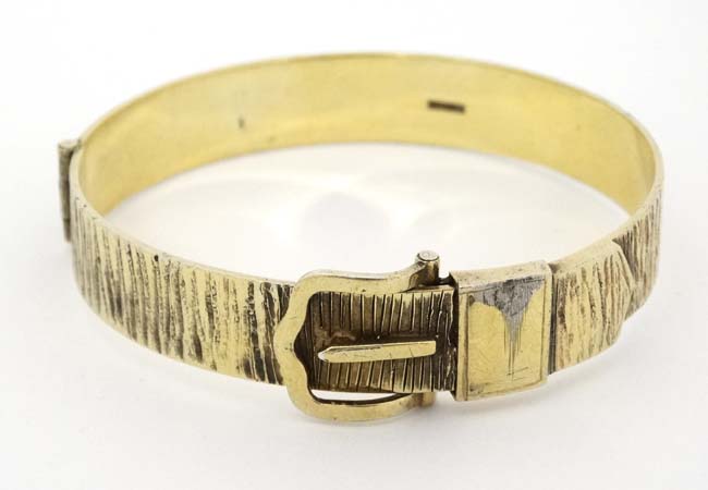 A silver gilt bracelet / bangle formed as a belt with buckle etc.