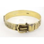 A silver gilt bracelet / bangle formed as a belt with buckle etc.