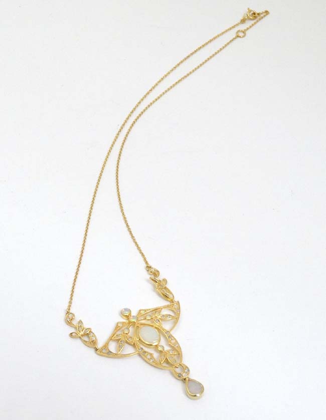 A silver gilt pedant and chain, the open work pendant set with a profusion of opals. - Image 3 of 5