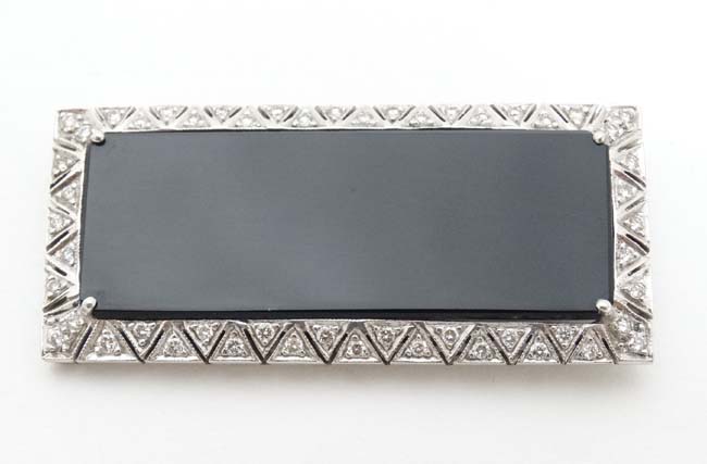 An unusual Art Deco style brooch set with central black onyx surrounded bordered by diamonds in a - Image 4 of 4