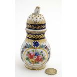 An 18thC Sevres Sampson style sugar caster / sifter decorated with polychrome flowers and gilt on a
