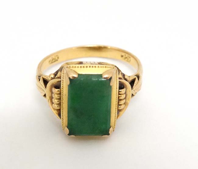 A Chinese 22ct gold ring set with jade like hardstone stone to top CONDITION: Please - Image 5 of 6