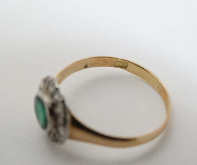 A 15ct gold ring set with central emerald bordered by diamonds CONDITION: Please - Image 2 of 5