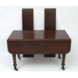 An early Victorian unusual mahogany extending Pembroke dining table with 2 leaves.