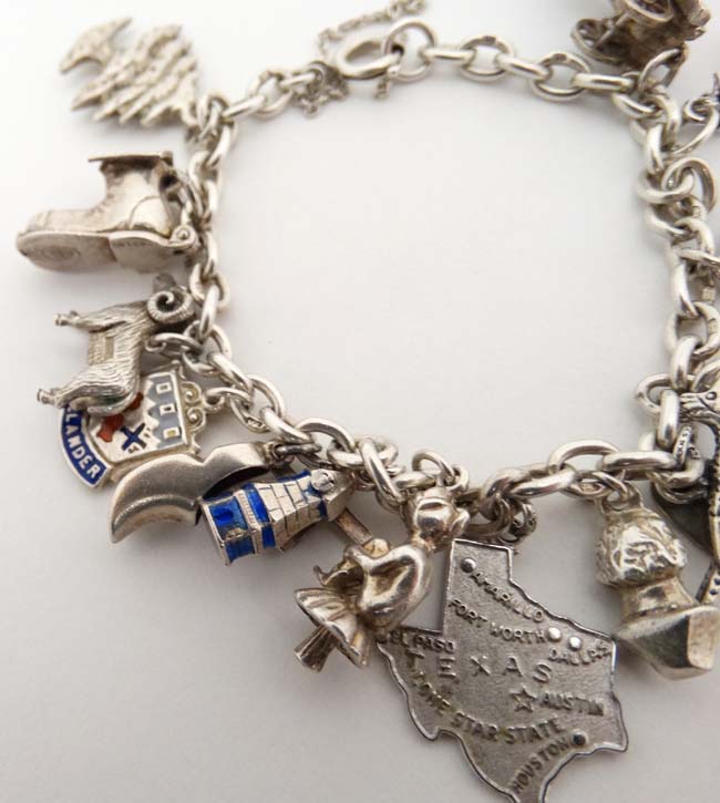 A silver charm bracelet set with 14 various silver and silver plate charms. - Image 3 of 5