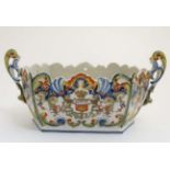 A 19thC Dinan, France, Faience pottery twin handlled jardiniere in a Quimper style,