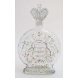 An old Decorative glass brandy bottle with gilt painted highlights and cast glass crown stopper,