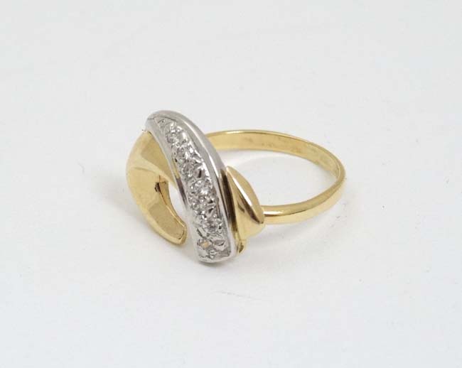 A 9ct gold ring with abstract design to top set with band of diamonds CONDITION: - Image 2 of 4