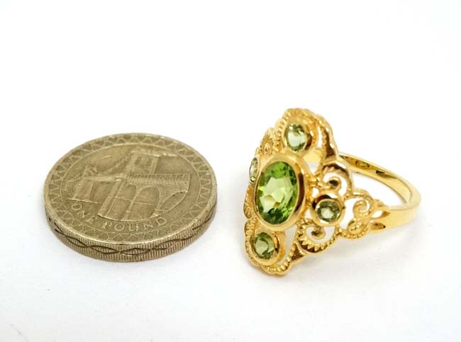 A silver gilt ring set with 5 peridot. - Image 3 of 4