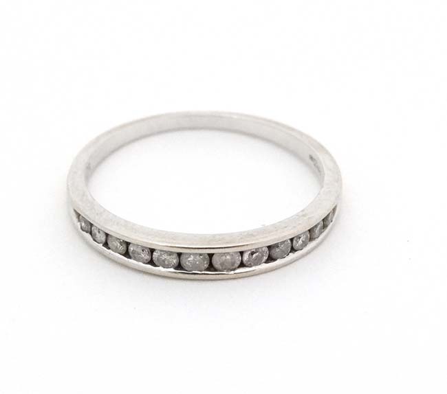 An 18ct white gold half eternity ring set with 12 diamonds CONDITION: Please Note