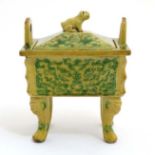 A small Chinese fang ding, the panels decorated in green with stylised face on a yellow ground,