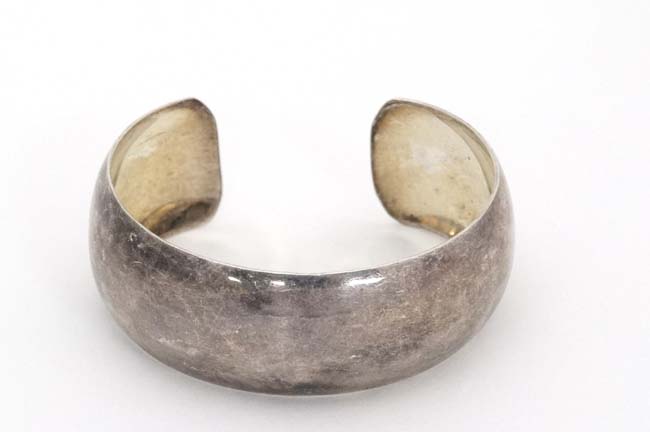 A silver bangle CONDITION: Please Note - we do not make reference to the condition