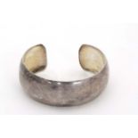A silver bangle CONDITION: Please Note - we do not make reference to the condition