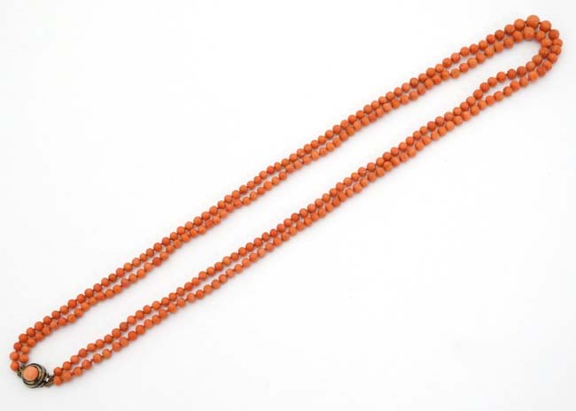 A vintage 2-strand coral graduated bead necklace with gilt metal clasp approx.