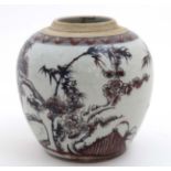 A Chinese red, black and white vase decorated with cherry blossom and bamboo on a rocky outcrop,