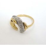 A 9ct gold ring with abstract design to top set with band of diamonds CONDITION: