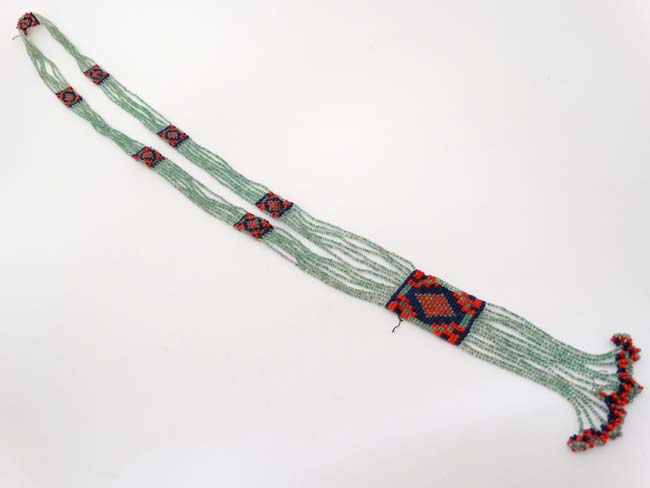 A vintage beadwork necklace with green blue and red bead decoration, hanging approx.