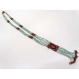 A vintage beadwork necklace with green blue and red bead decoration, hanging approx.