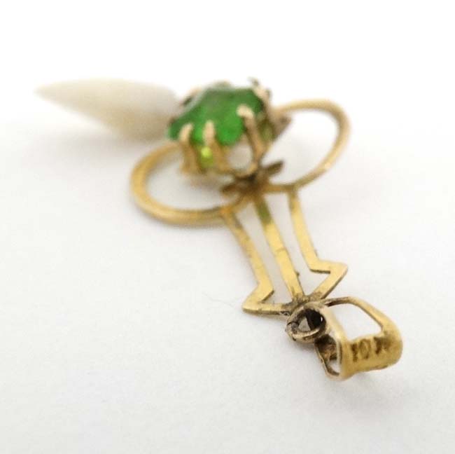 A gilt metal pendant set with green stone and mother of pearl drop CONDITION: - Image 3 of 4