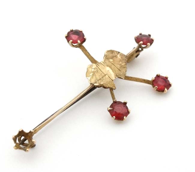 A 9ct gold ' Southern Cross' brooch with outline of Australia to centre and set with red stones.