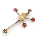 A 9ct gold ' Southern Cross' brooch with outline of Australia to centre and set with red stones.