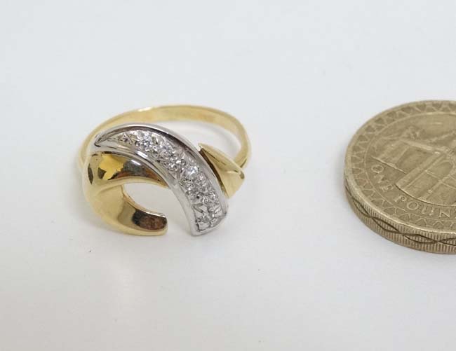 A 9ct gold ring with abstract design to top set with band of diamonds CONDITION: - Image 3 of 4