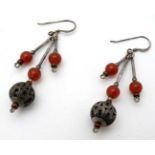 A pair of silver and white metal drop earrings with filigree like spherical decoration and