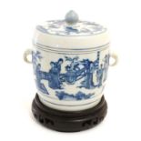 A Chinese blue and white twin handled pot and cover on wooden stand ,