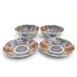 A pair of Japanese Imari plates and matching pair of bowls,