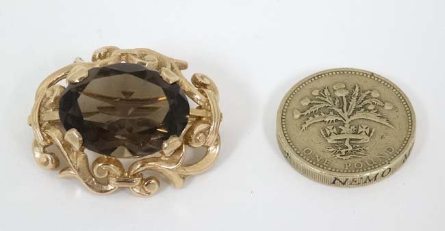 A 9ct gold brooch set with central facet cut smokey quartz within a scrolling mount. - Image 4 of 5