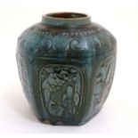 A Chinese Green stoneware ginger jar having panels decorated with figures, script and trees.