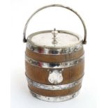 An ice bucket of barrel form with banded silver plate mounts, handle and lid , and ceramic liner.