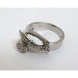 An 18ct white gold cocktail ring set with a profusion of diamonds CONDITION: Please
