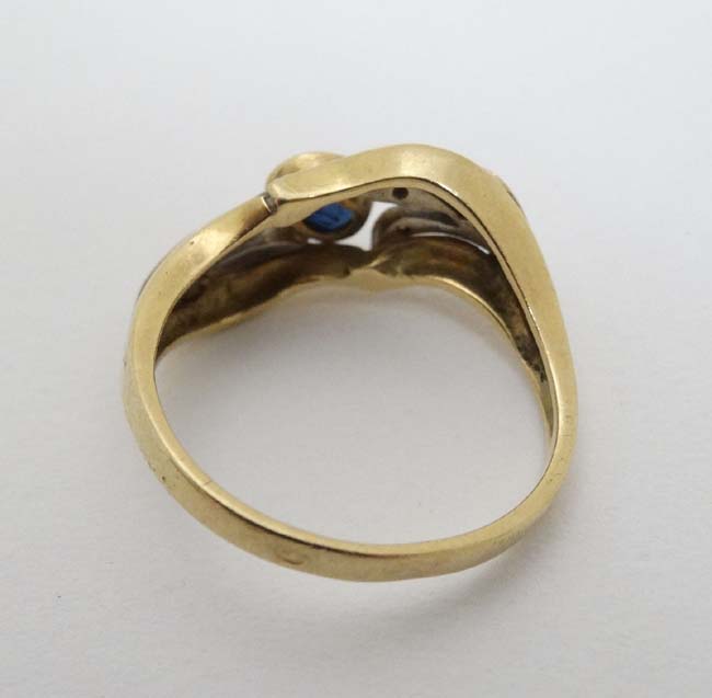 An unusual 18ct gold ring set with central sapphire in a foliate setting with chip set diamonds - Image 4 of 5