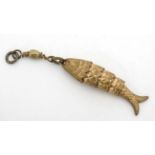 A gilt metal pendant / charm formed as an articulated fish.