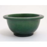 A green Chinese stoneware bowl, bearing label for the 'MJ Coltman Collection' . 6'' diameter.