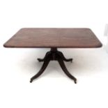A circa 1800 mahogany tilt top / Breakfast table with turned pedestal and four reeded legs and