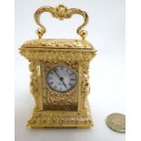 Carriage Clock : an ornate gilded brass miniature late 20 thC Carriage Clock,