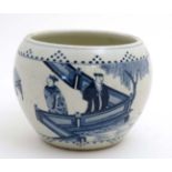A Chinese blue and white pot , decorated with figures and gaurds on a terrace beside a koi pond,