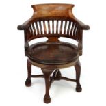 A c.1900 oak swivel office chair of captains style on 4-legs.