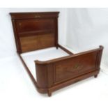 An early 20thC Empire style mahogany bed.